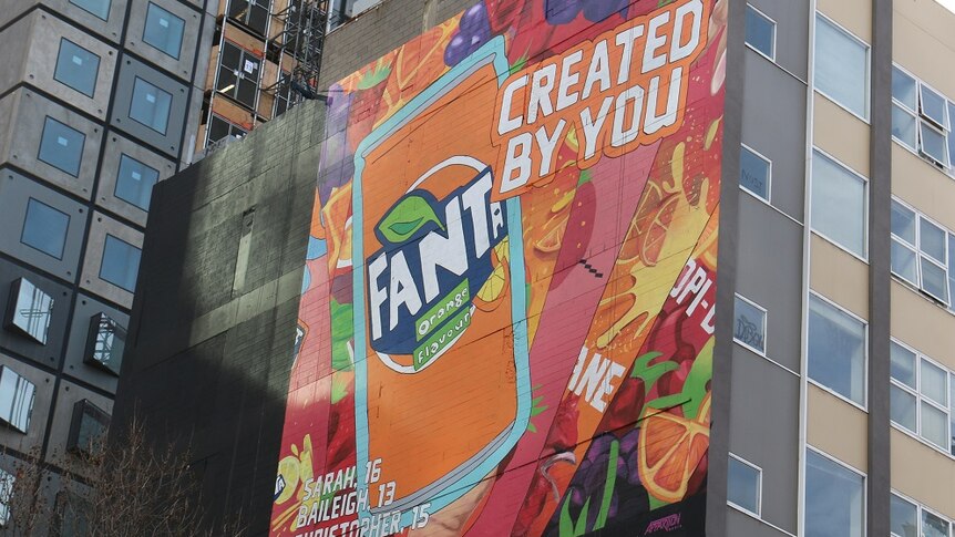 A street art-style advertisement for Fanta, brightly coloured and covering a large building wall in Melbourne.