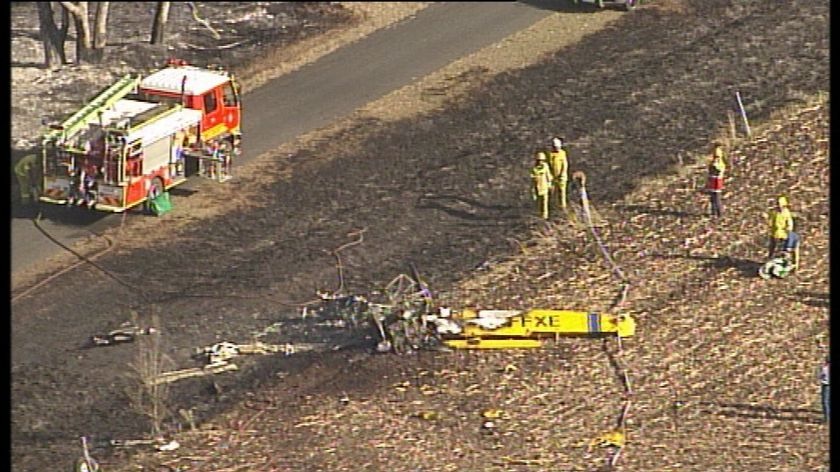 Firefighters survey the wreckage of the crop duster.
