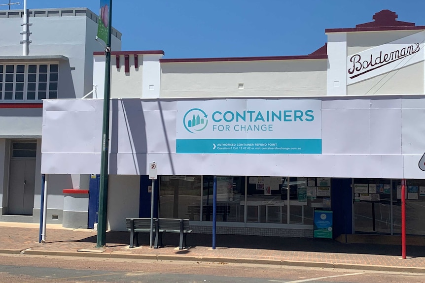 The Longreach Containers for Change building sits in full sun, a white building with a sign.