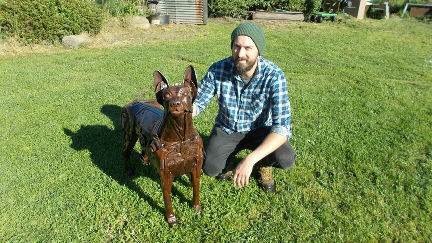 A man and his dog, the former constructed with metal.