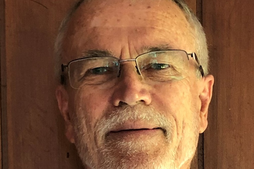A close up photo of a man with a white beard