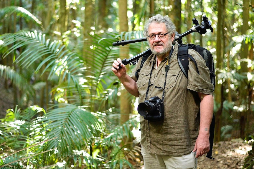 Wildlife Photographer Steve Parish with tripod over shoulder.