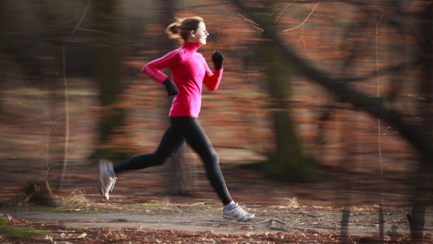 A woman running through a park