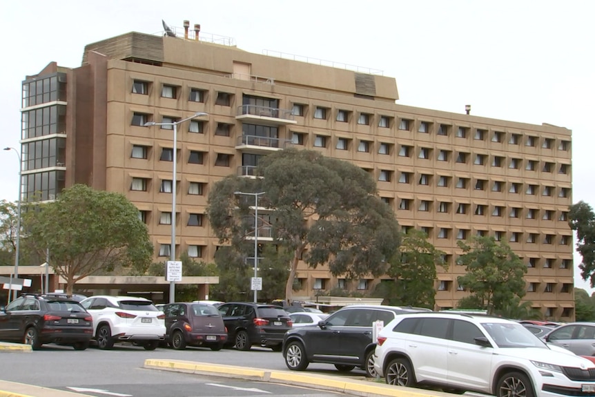 A large brown building with lots of windows