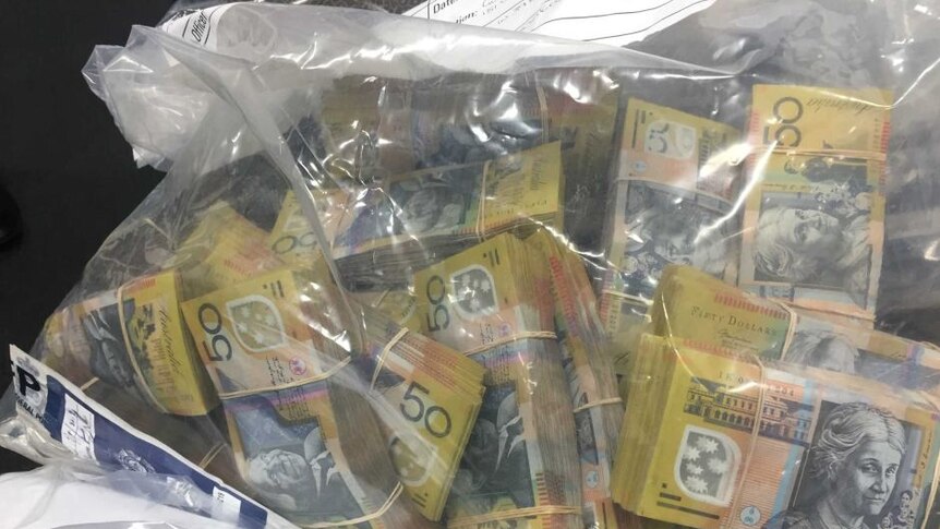 Cash seized by AFP over tax office fraud.