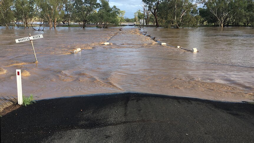 The old bridge over the Warrego River at Charleville is covered by fast-moving floodwaters