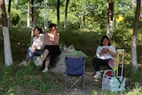 three Beijing residents camping and picnicking outdoors 