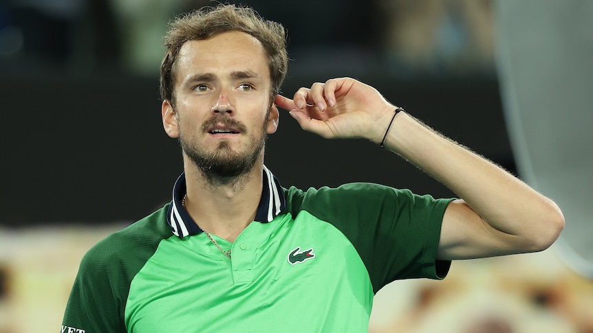 Daniil Medvedev points to his head after winning his Australian Open semifinal.