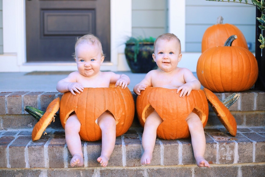 Two babies sitting in pumpkin shells to depict Halloween 2019 baby costume ideas that are safe and comfortable.