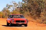 Old red Holden on dirt road