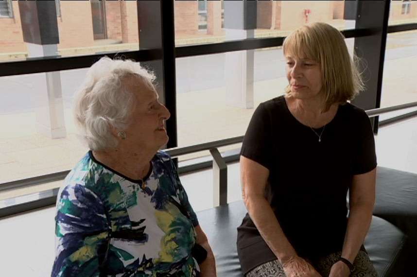 Professor Elizabeth Rakoczy and Gwenda Boultbee seated with window in background