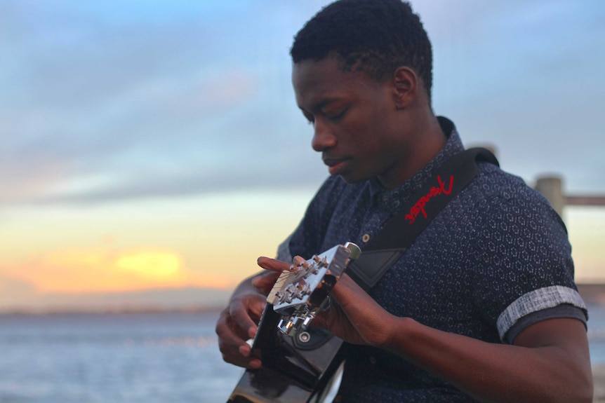 A man playing guitar.