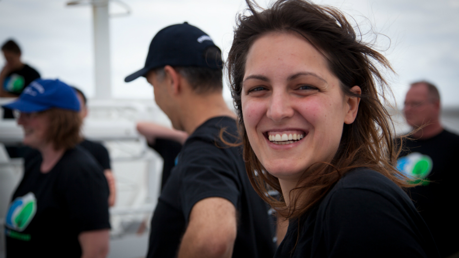 Eva Fernandez smiles at the camera on board a scientific research ship