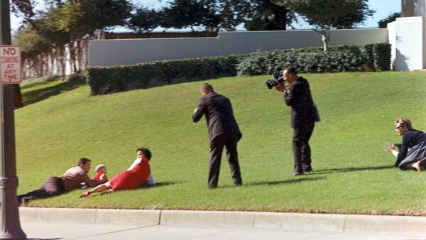 Bill and Jean Newman and their children fall on the grass moments after the assassination of JFK.