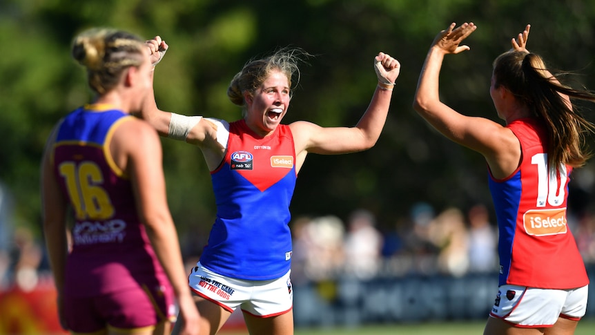 Katherine Smith of the Demons celebrates kicking a goal against the Lions.