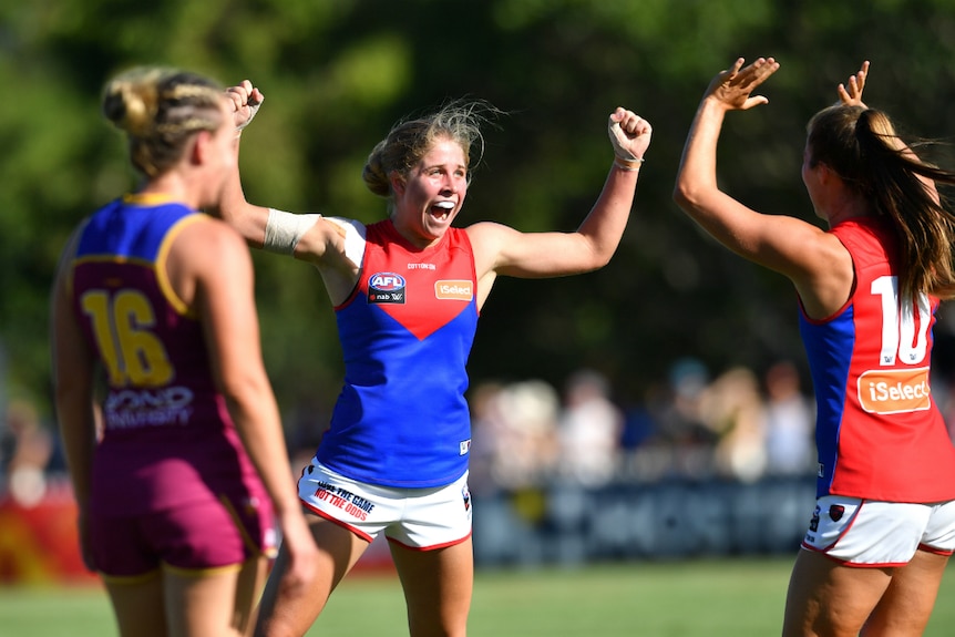 Katherine Smith of the Demons celebrates kicking a goal against the Lions.