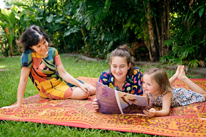 Professor Anna Ralph watches as Bridget Myerscough reads to Vita.