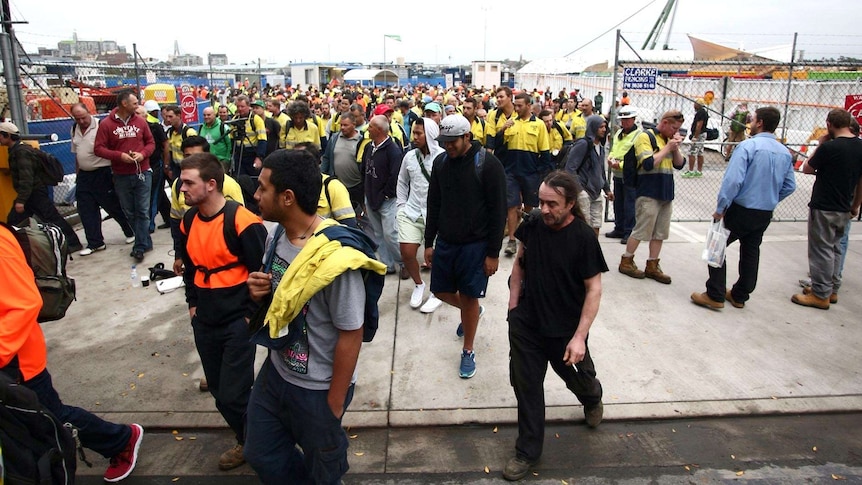 Workers at the Barangaroo construction site in the Sydney CBD head home after a fire at the site.