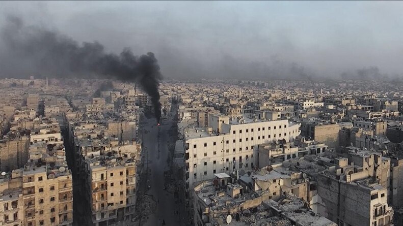 Black smoke rises to the sky in a number of locations among damaged and ruined city scape in Aleppo, Syria on overcast day.