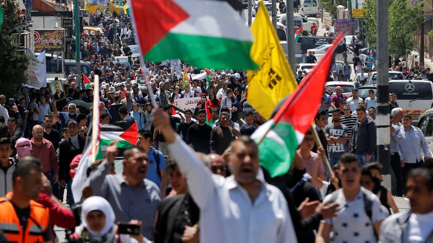Palestinians take part in a protest in solidarity with Palestinian prisoners