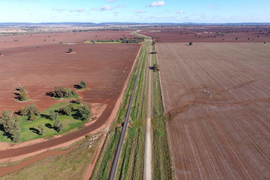 Bird's eye view of railway running through two fields near Gunningbland in NSW.