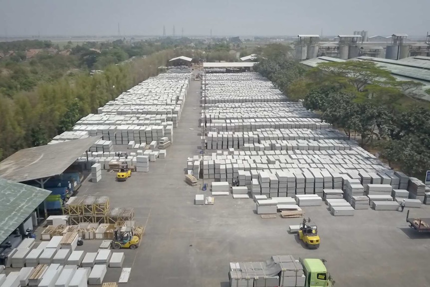 A drone shot of an Indonesian factory processing white asbestos for building materials