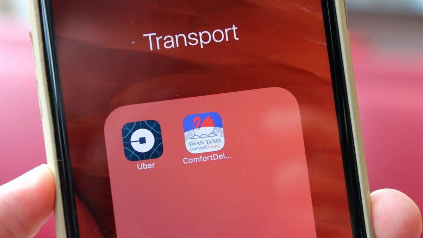 Uber and Swan Taxis app logos are displayed on an iPhone with a red screen.