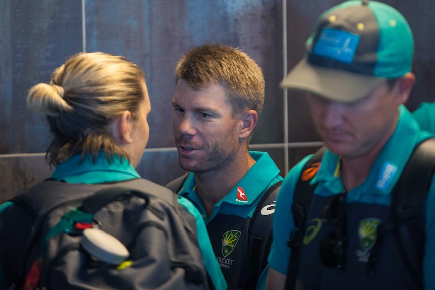 David Warner arrives with teammates at the Cape Town International airport.