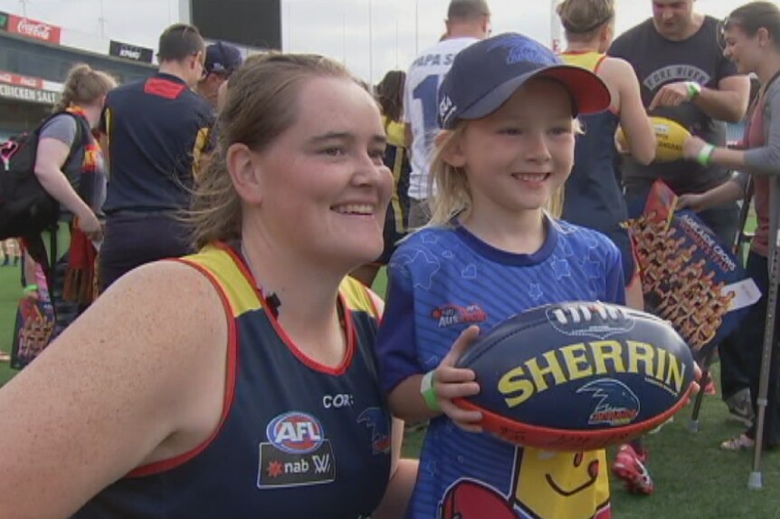 Adelaide Crows forward, Sarah Perkins, with a young fan