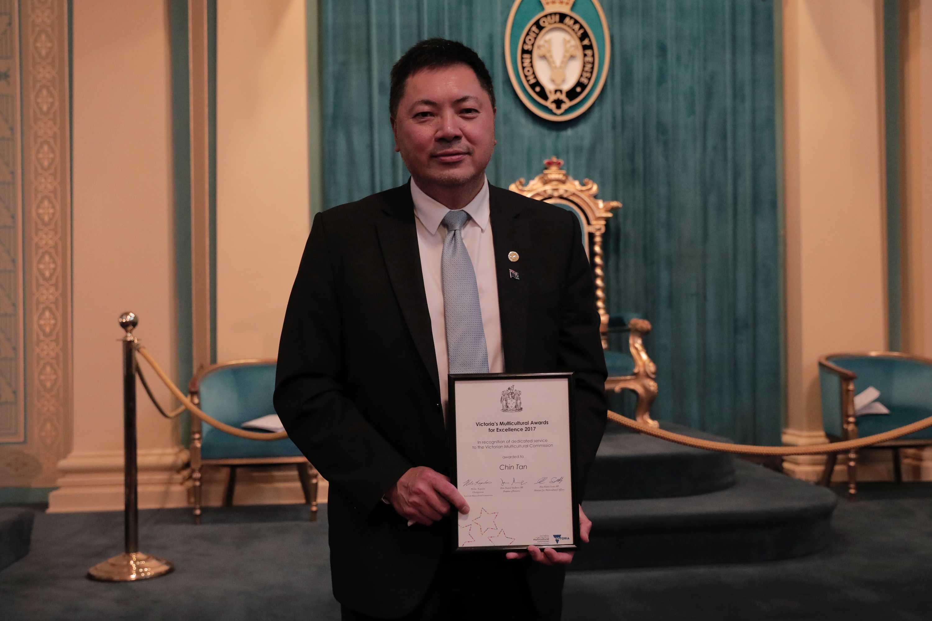 Mr Tan is pictured at the Victorian Multicultural Excellence Awards in 2017, holding his award.