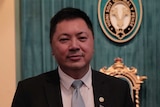 Mr Tan is pictured at the Victorian Multicultural Excellence Awards in 2017, holding his award.