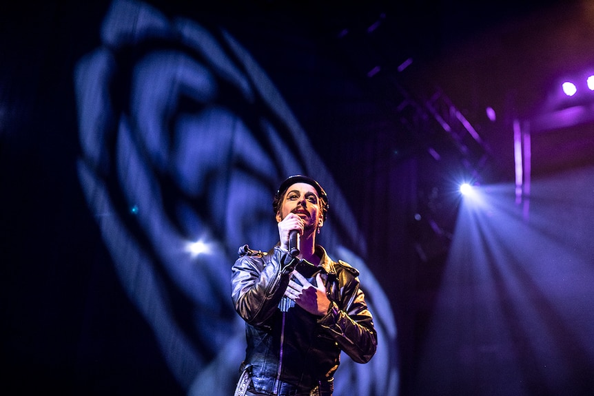 Colour photo of singer, songwriter and actor Brendan Maclean performing on stage at Day for Night 2018.