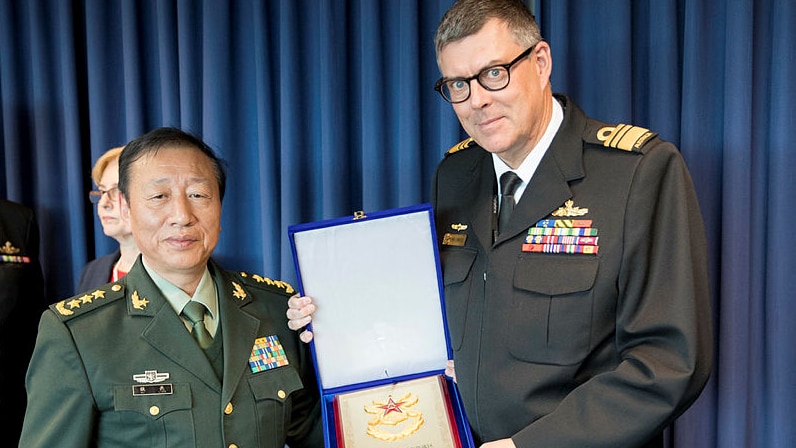 Vice Admiral Ray Griggs exchanges gifts with General Wei Liang after military talks in Canberra.