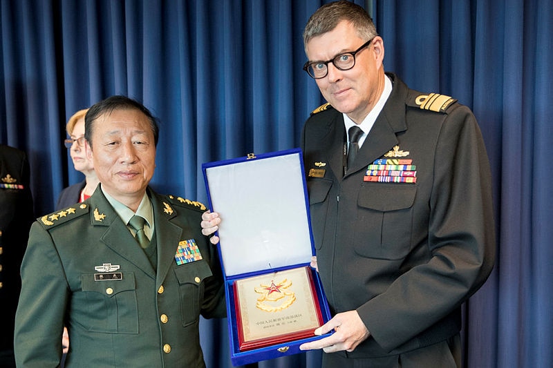 Vice Admiral Ray Griggs exchanges gifts with General Wei Liang after military talks in Canberra.