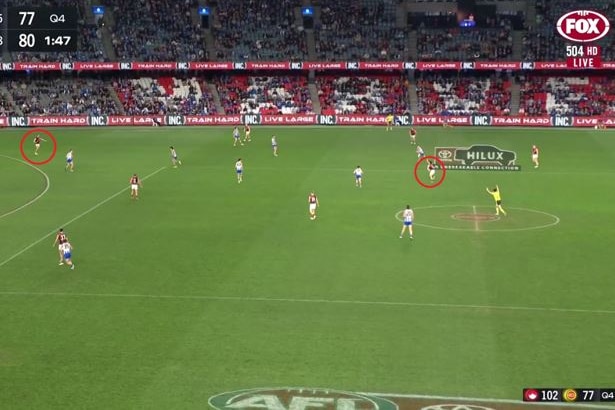 A screenshot of footage looking across the ground at Docklands, with two Essendon players circled in red.
