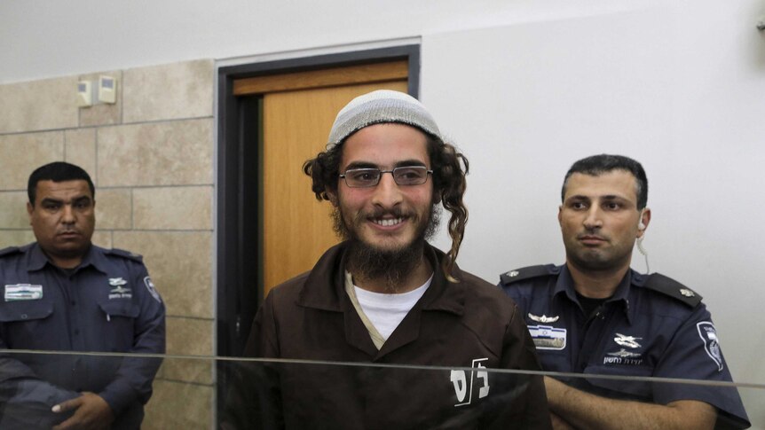 Far-right activist Meir Ettinger (C) attends a remand hearing at the Magistrates Court in Nazareth, Israel