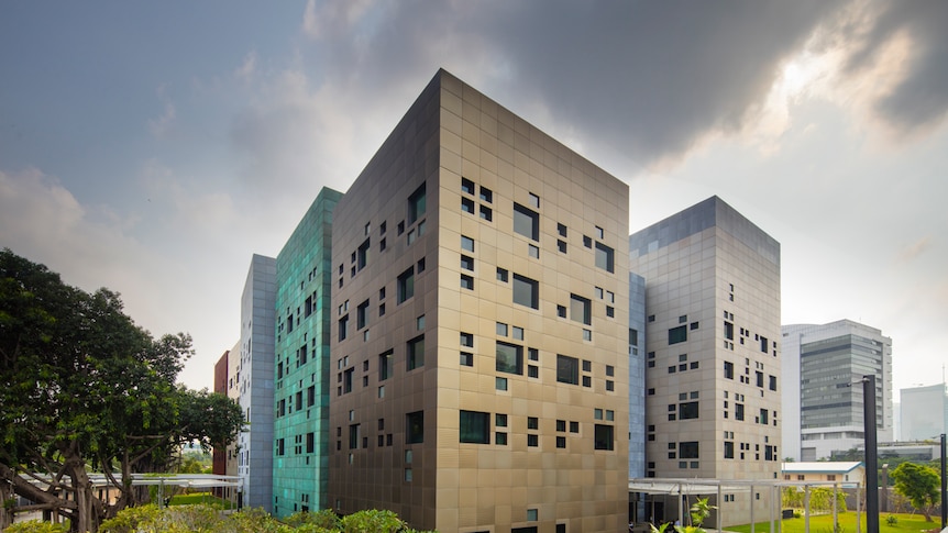 A photo shows the architecture of Australia's Jakarta Embassy in front of a cloudy sky.