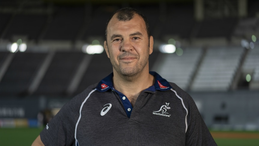 Wallabies coach Michael Cheika smiles at the camera.