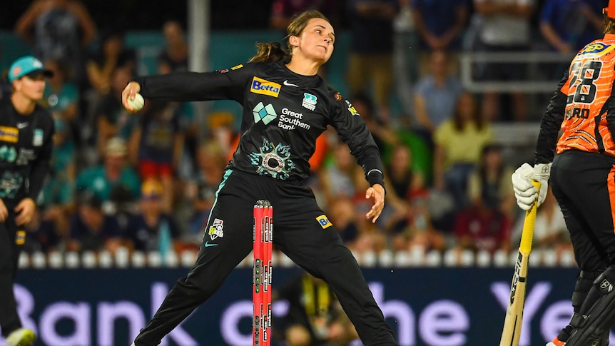 A spin bowler is photographed about to deliver the ball in a Women's Big Bash League game.