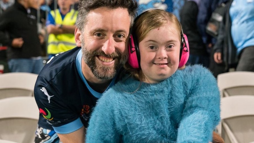 man and young daughter in Sydney FC blue colours