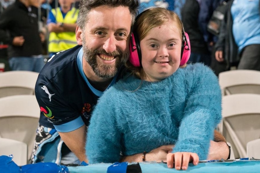 man and young daughter in Sydney FC blue colours