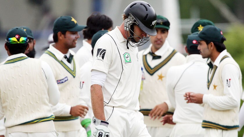Tim McIntosh walks off after being dismissed lbw by Mohammad Asif (4 for 41).