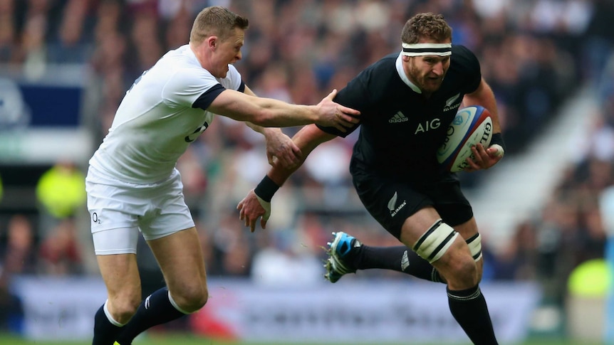 All Black Kieran Read (R) tries to evade the tackle of England's Chris Ashton.