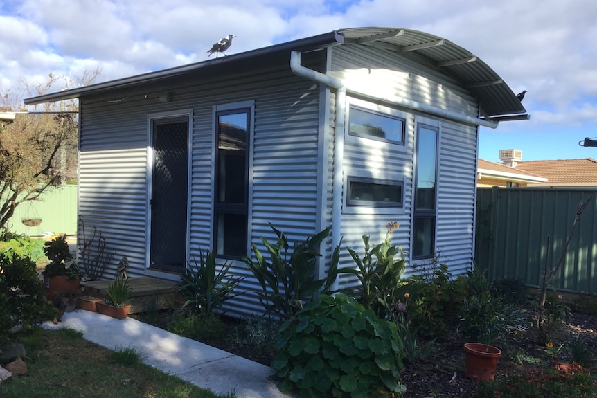 A bungalow in a back yard