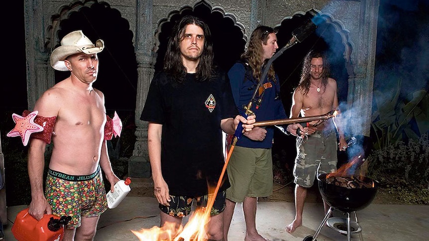 Tool stand around a barbecue with gasoline and flames. Maynard Keenan wears underwear and floaties