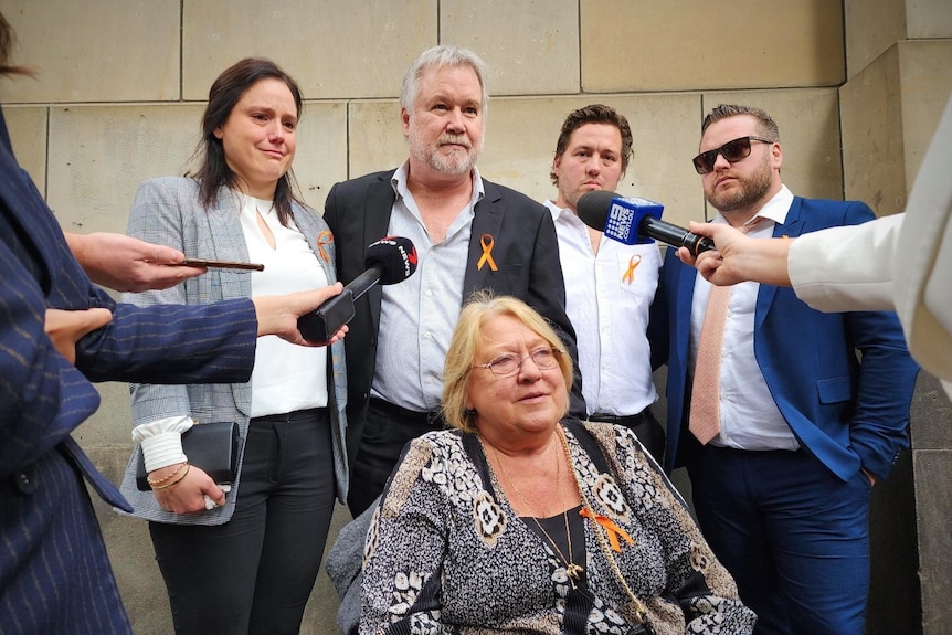 Five adults pictured outside court