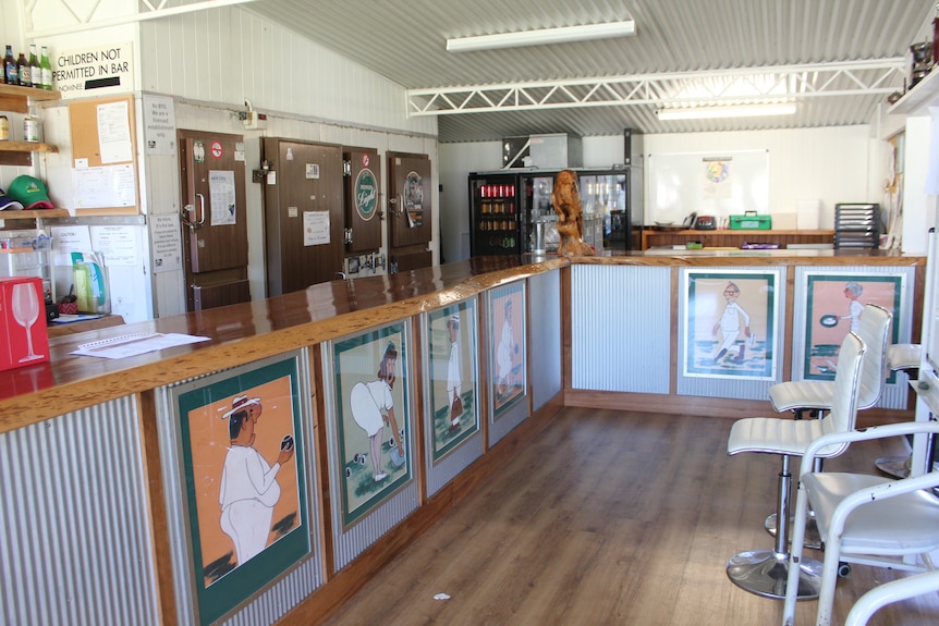 Bar of Canungra bowls club including caricatures of male and female bowlers drawn by former member hanging on wall underneath ba
