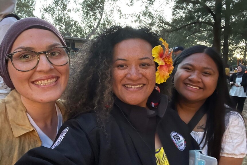 Three women smiling.