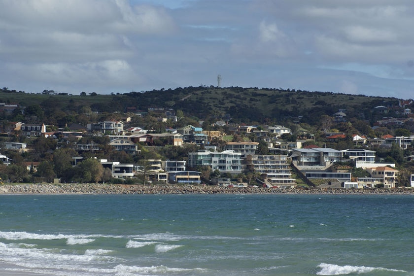 Houses on a hill next to the sea