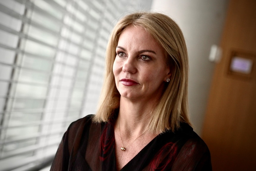 Barrenjoey Capital Partners chief economist Jo Masters sits next to a window.